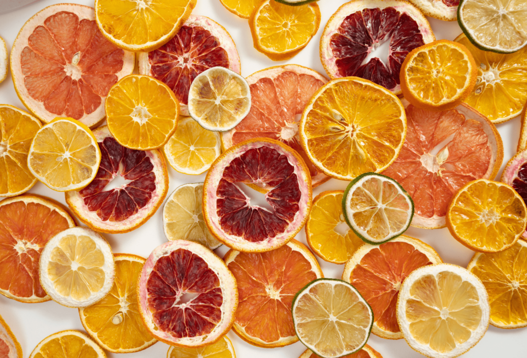 overhead view of array of dried citrus wheels including blood oranges, navel oranges, lemons, and limes.
