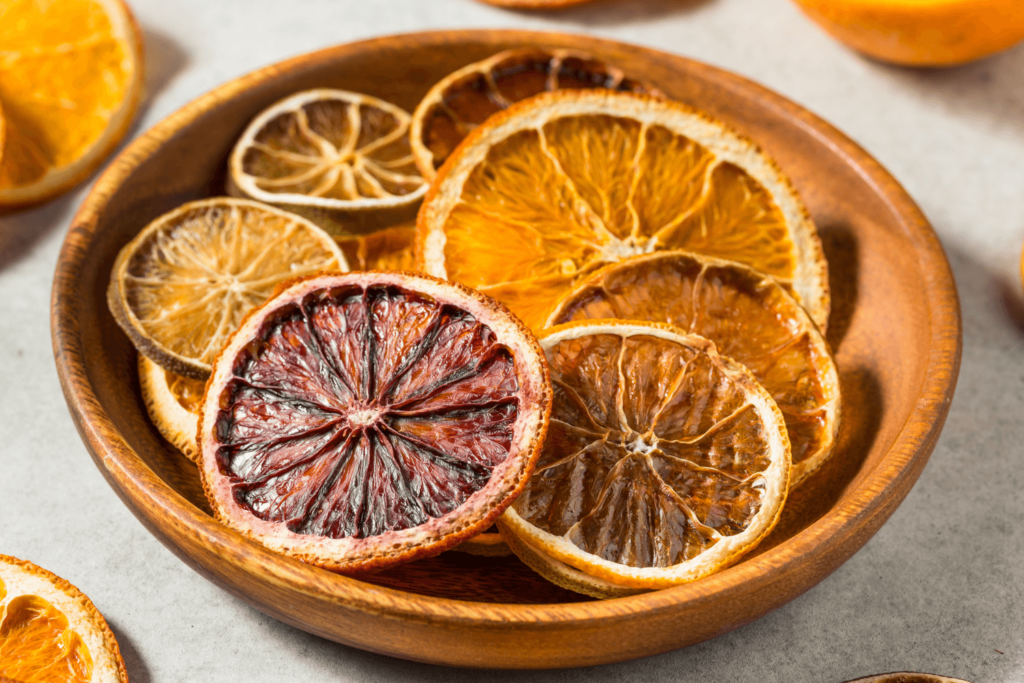 variety of dried citrus fruits in a wooden bowl