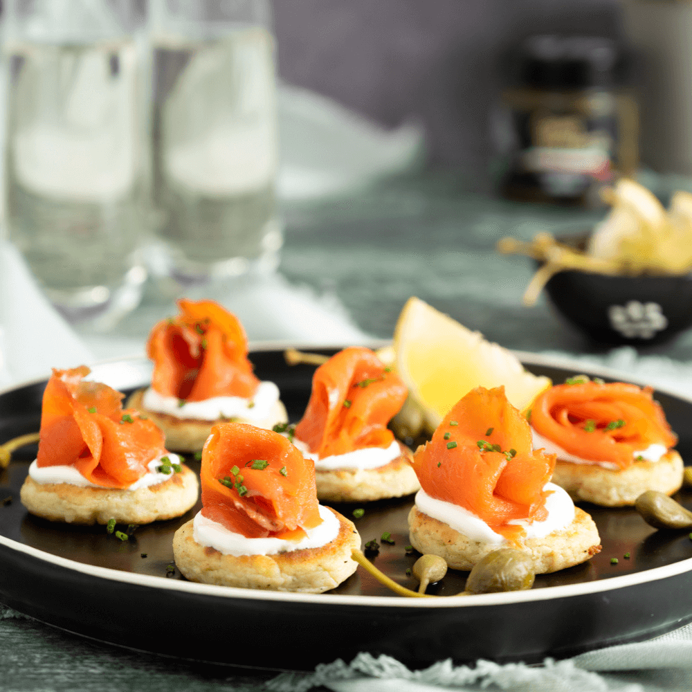 Holiday Appetizer Recipe: black plate filled with smoked salmon canapes.