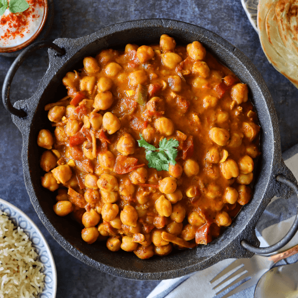 Overhead shot of cast iron skillet filled with chickpea curry.