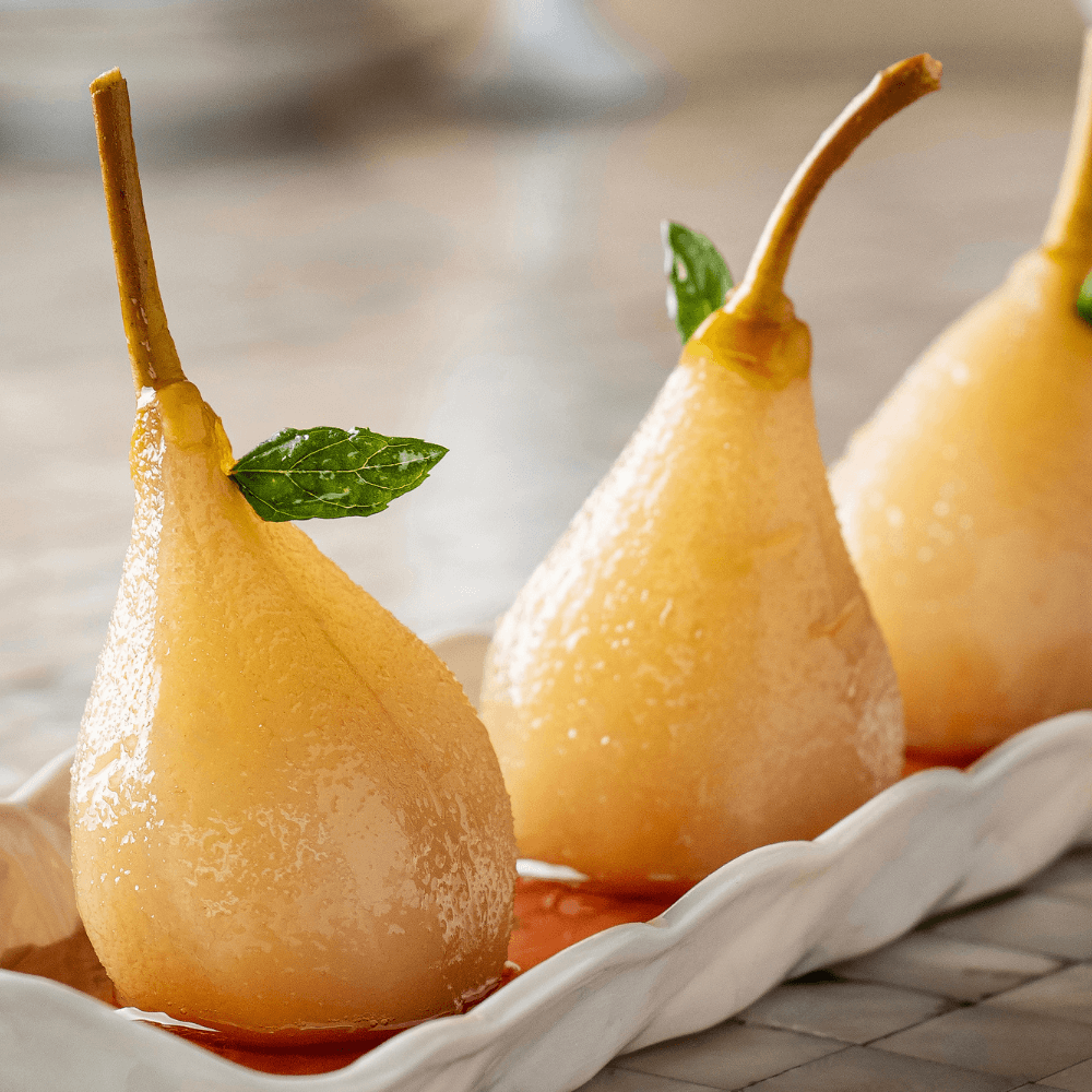 Honey ginger poached pears in a dish.