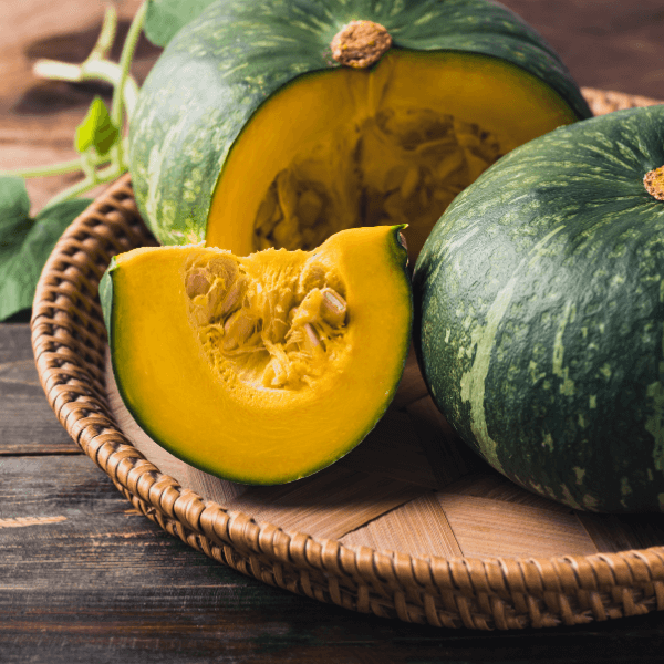 Green pumpkin in basket on wooden background, Organic vegetable