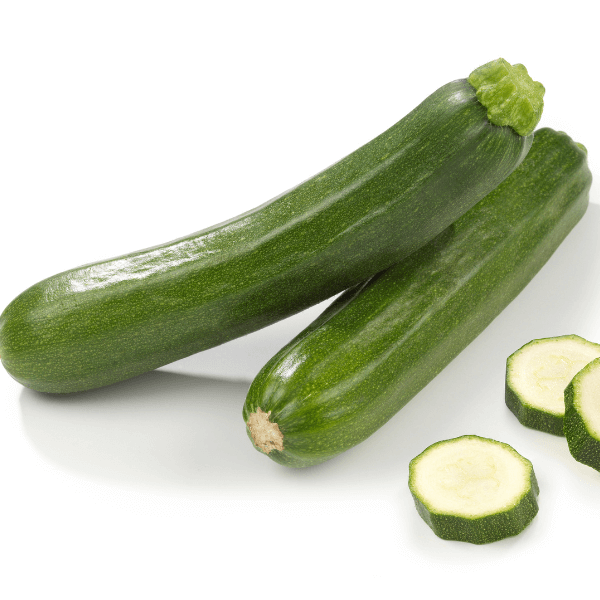 Two whole zucchini and three zucchini rounds on white background.