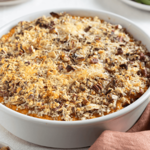 Try this Sweet Potato Bake with Pecans and Crispy Onions for the perfect holiday side dish! Made with creamy sweet potatoes, topped with crunchy pecans, crispy onions, and Parmigiano Reggiano.