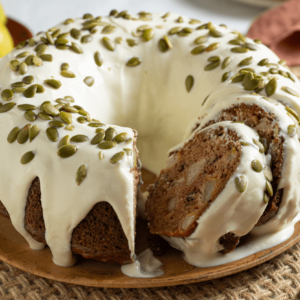 Old Fashioned Pear Spice Bundt Cake with cream cheese glaze and one slice removed.