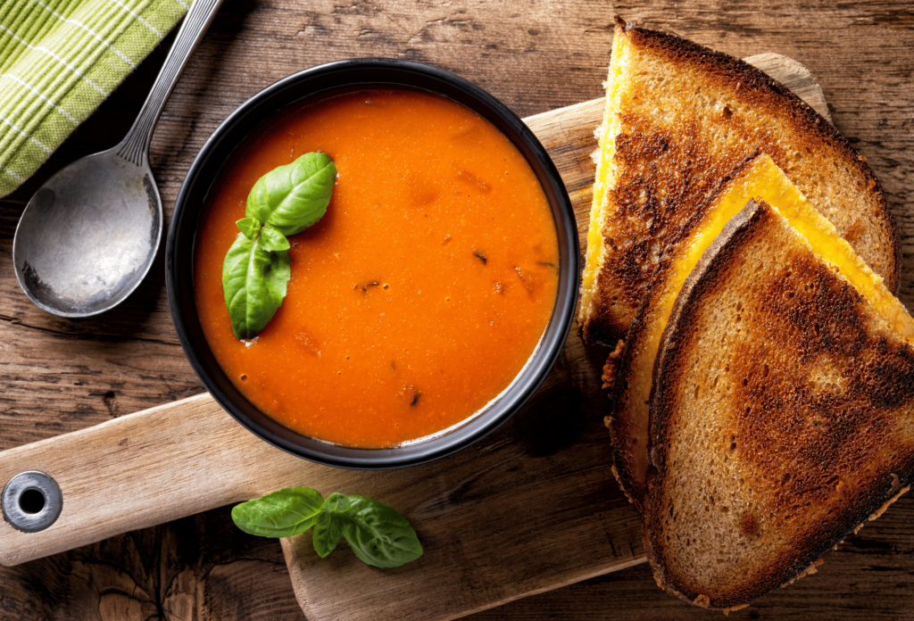 Delicious homemade tomato soup with a grilled cheese sandwich on rye.